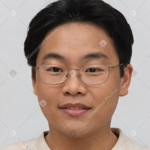 Joyful asian young-adult male with short  brown hair and brown eyes