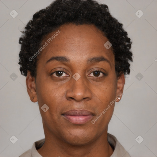 Joyful black adult female with short  brown hair and brown eyes