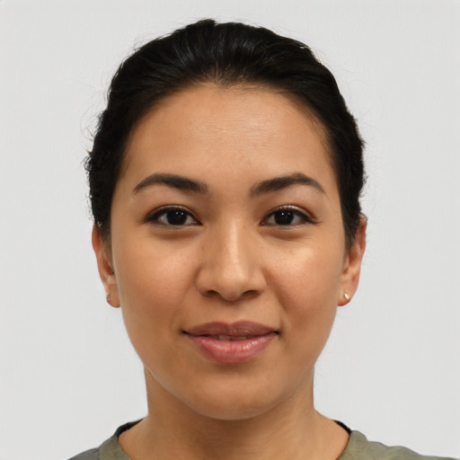 Joyful latino young-adult female with short  brown hair and brown eyes