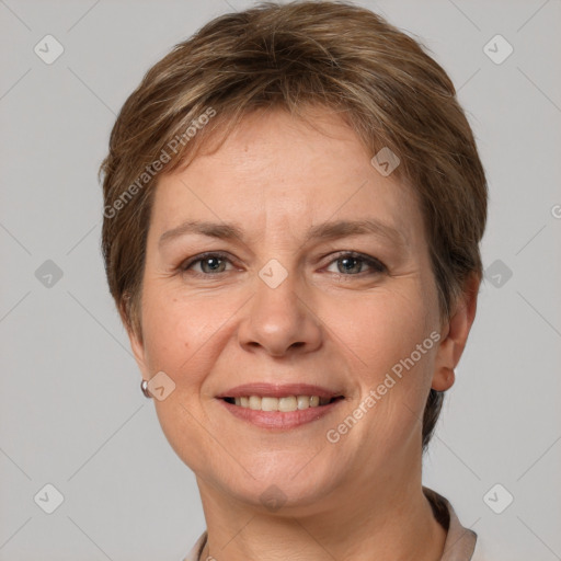 Joyful white adult female with short  brown hair and grey eyes