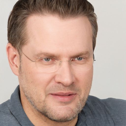 Joyful white adult male with short  brown hair and grey eyes