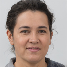 Joyful white adult female with medium  brown hair and brown eyes