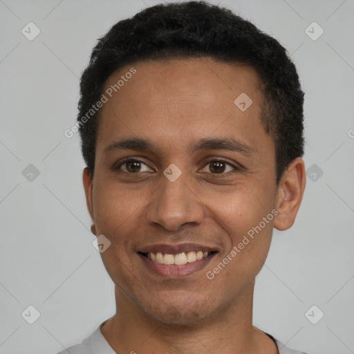 Joyful latino young-adult male with short  black hair and brown eyes