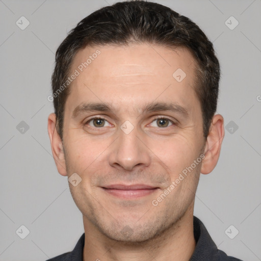 Joyful white adult male with short  brown hair and brown eyes