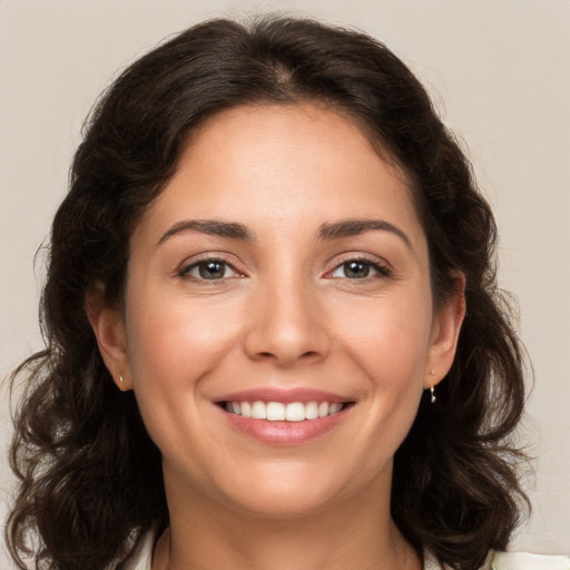 Joyful white young-adult female with medium  brown hair and brown eyes