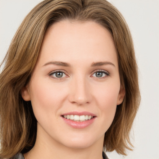 Joyful white young-adult female with long  brown hair and green eyes