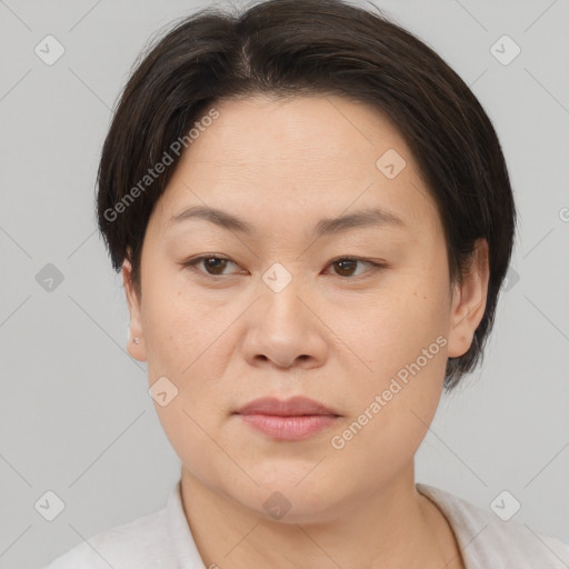 Joyful asian young-adult female with short  brown hair and brown eyes