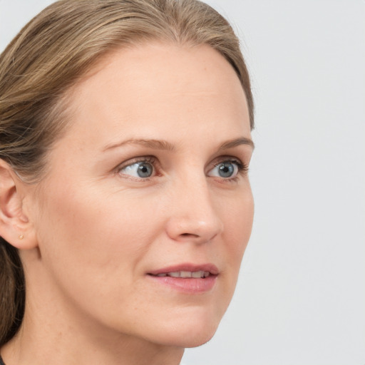 Joyful white young-adult female with medium  brown hair and blue eyes