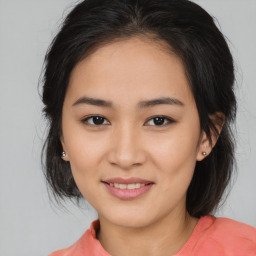 Joyful asian young-adult female with medium  brown hair and brown eyes