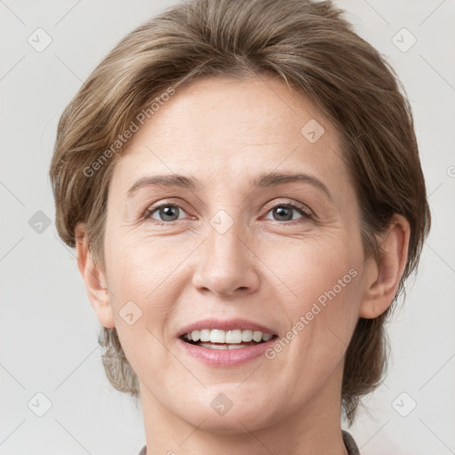 Joyful white adult female with medium  brown hair and grey eyes