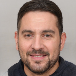 Joyful white adult male with short  brown hair and brown eyes