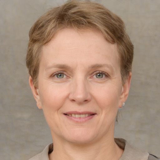 Joyful white adult female with short  brown hair and grey eyes