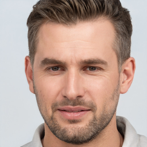 Joyful white adult male with short  brown hair and brown eyes