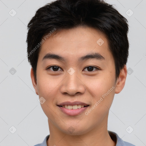 Joyful asian young-adult male with short  black hair and brown eyes