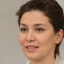 Joyful white adult female with medium  brown hair and brown eyes