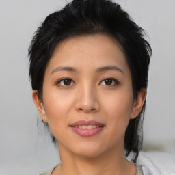 Joyful asian young-adult female with medium  black hair and brown eyes