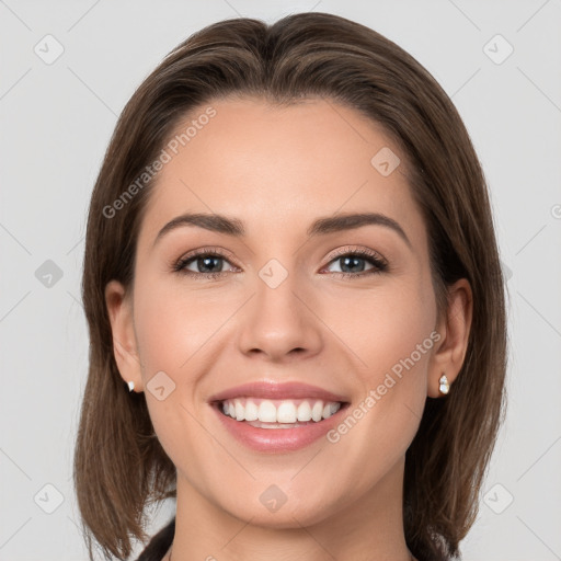 Joyful white young-adult female with medium  brown hair and grey eyes