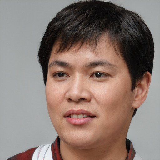 Joyful asian young-adult male with short  brown hair and brown eyes