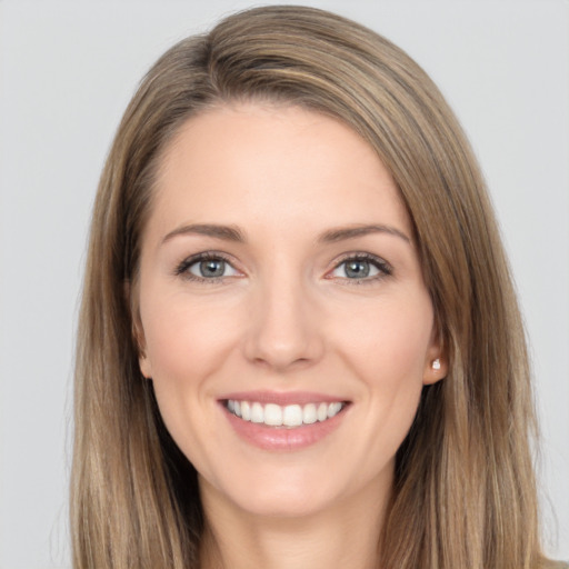 Joyful white young-adult female with long  brown hair and brown eyes