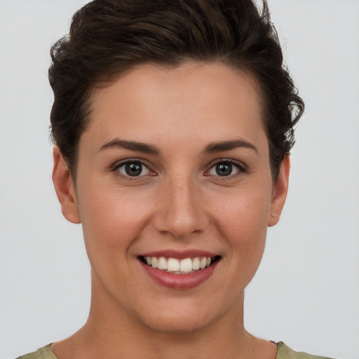 Joyful white young-adult female with short  brown hair and brown eyes