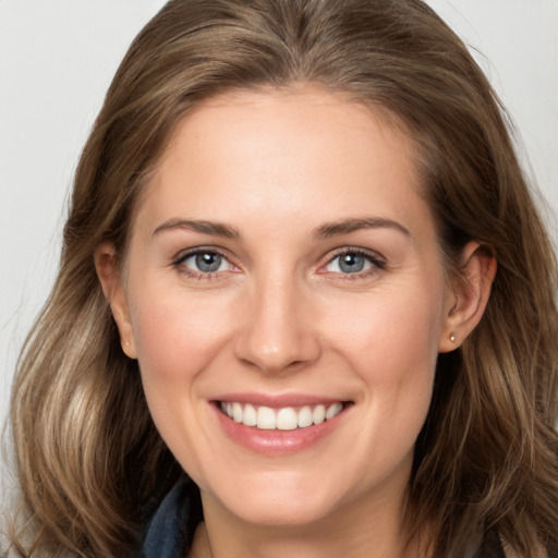 Joyful white young-adult female with long  brown hair and grey eyes