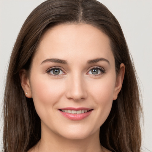 Joyful white young-adult female with long  brown hair and grey eyes