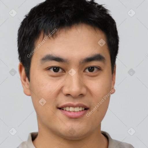 Joyful asian young-adult male with short  brown hair and brown eyes