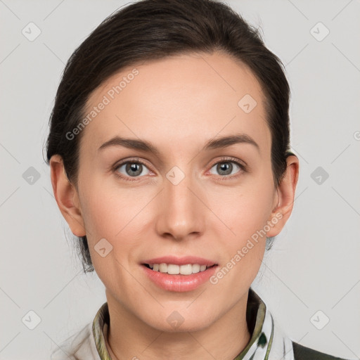 Joyful white young-adult female with medium  brown hair and grey eyes