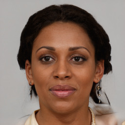 Joyful black adult female with medium  brown hair and brown eyes