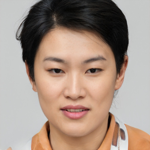 Joyful asian young-adult female with short  brown hair and brown eyes