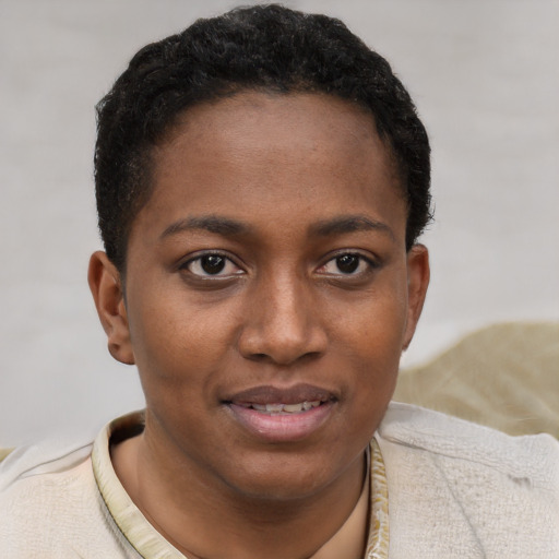 Joyful black young-adult female with short  brown hair and brown eyes