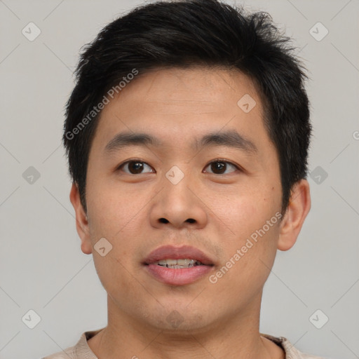 Joyful asian young-adult male with short  brown hair and brown eyes