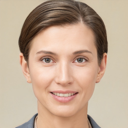 Joyful white young-adult female with short  brown hair and grey eyes