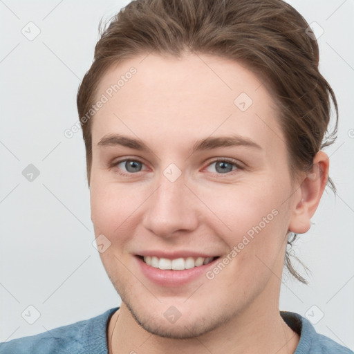 Joyful white young-adult female with short  brown hair and grey eyes