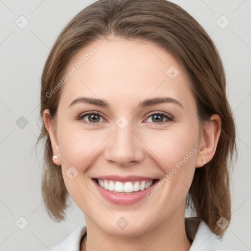 Joyful white young-adult female with medium  brown hair and grey eyes