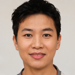 Joyful asian young-adult male with short  black hair and brown eyes