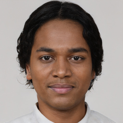 Joyful black young-adult male with short  black hair and brown eyes