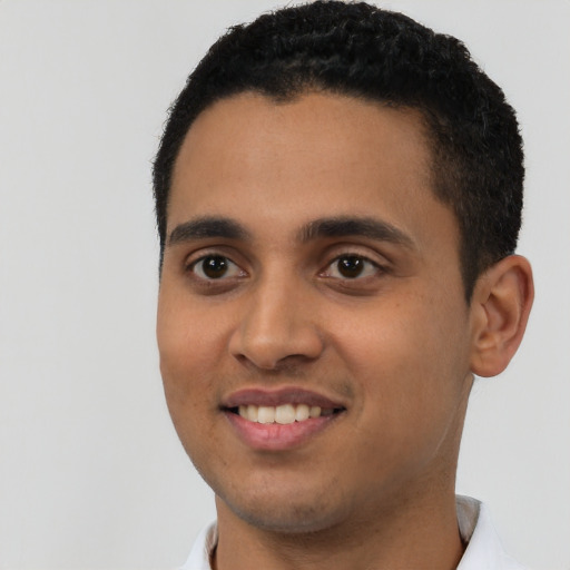 Joyful latino young-adult male with short  black hair and brown eyes