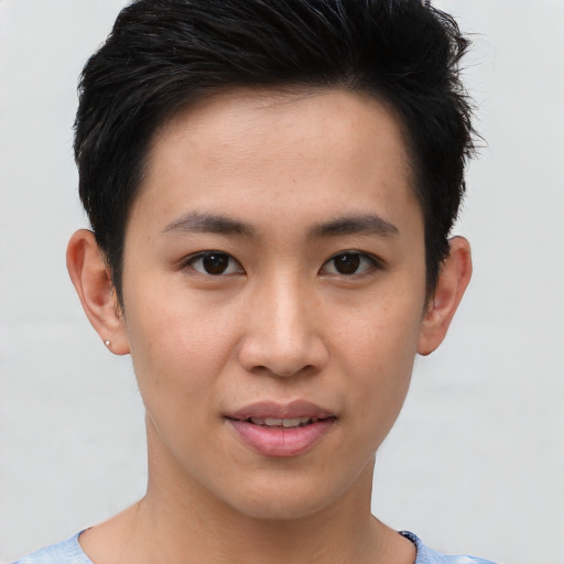 Joyful asian young-adult male with short  brown hair and brown eyes