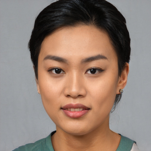 Joyful asian young-adult female with medium  black hair and brown eyes