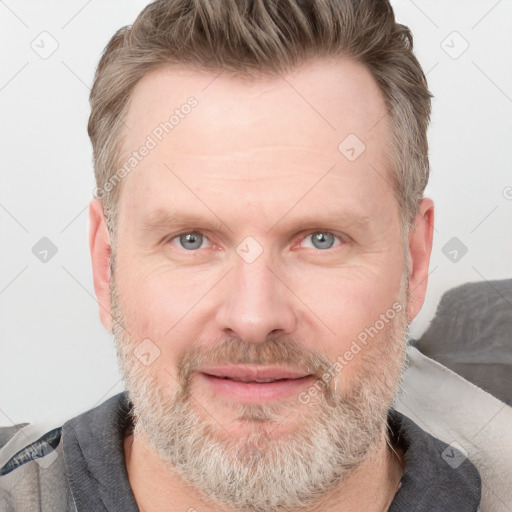 Joyful white adult male with short  brown hair and grey eyes