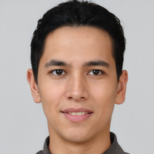 Joyful asian young-adult male with short  black hair and brown eyes