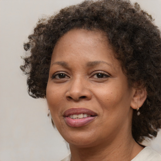 Joyful black adult female with medium  brown hair and brown eyes