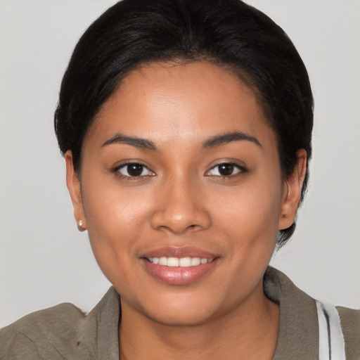 Joyful latino young-adult female with short  black hair and brown eyes