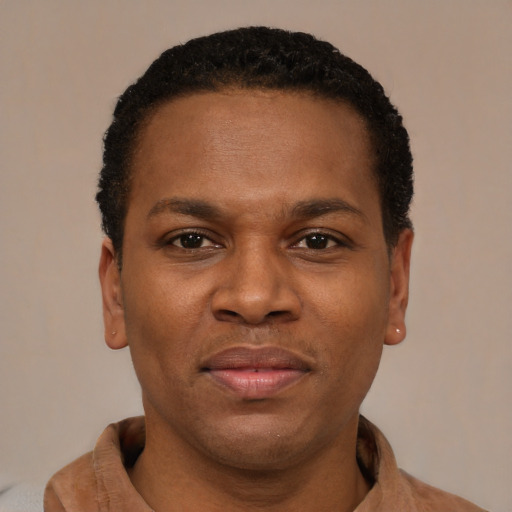 Joyful latino adult male with short  brown hair and brown eyes