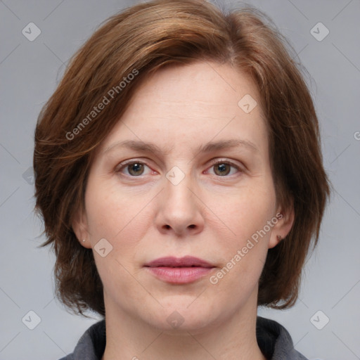 Joyful white adult female with medium  brown hair and grey eyes