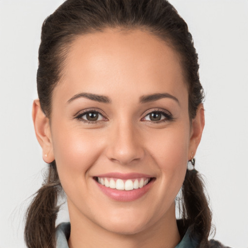 Joyful white young-adult female with medium  brown hair and brown eyes