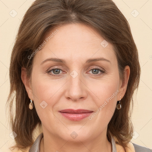 Joyful white adult female with medium  brown hair and grey eyes