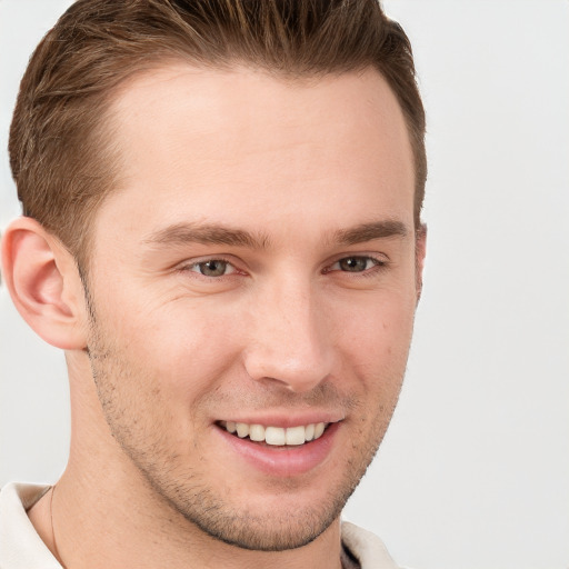 Joyful white young-adult male with short  brown hair and grey eyes