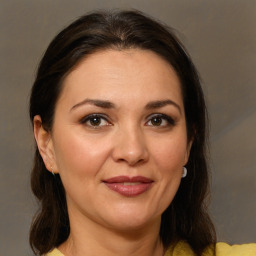 Joyful white adult female with medium  brown hair and brown eyes